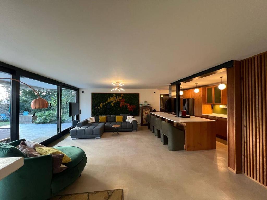 a large living room with couches and a table at Forest Haus in Schlangenbad