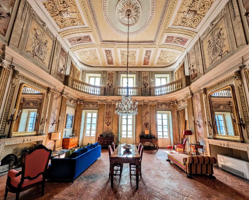 a large room with a ceiling with a chandelier at Appartamento Principe in Menaggio