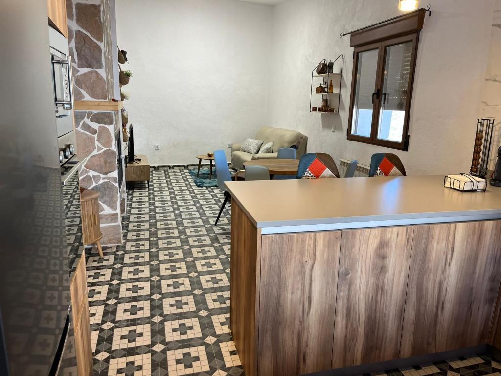 a lobby with a counter and a living room at La casa de Inocen in Cilleruelo