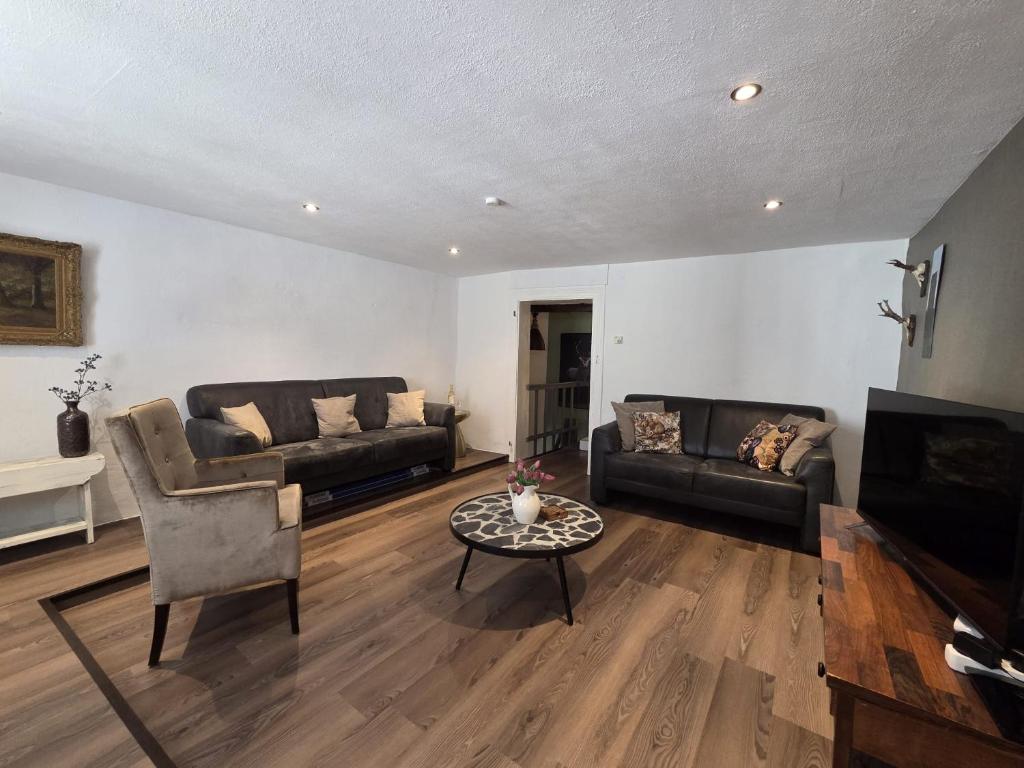 a living room with two couches and a table at Der kleine Eifel-Ritter in Manderscheid