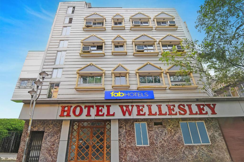 a hotel building with a hotel sign in front of it at FabHotel Wellesley in Kolkata