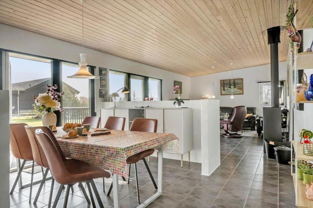 a kitchen and dining room with a table and chairs at LF10202-Thyholm-Markvejen-2 in Thyholm