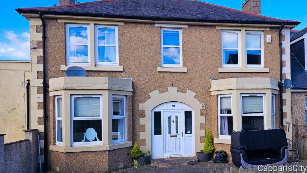 a brown brick house with a white door at 12A-2 Stobhill Road in Arniston