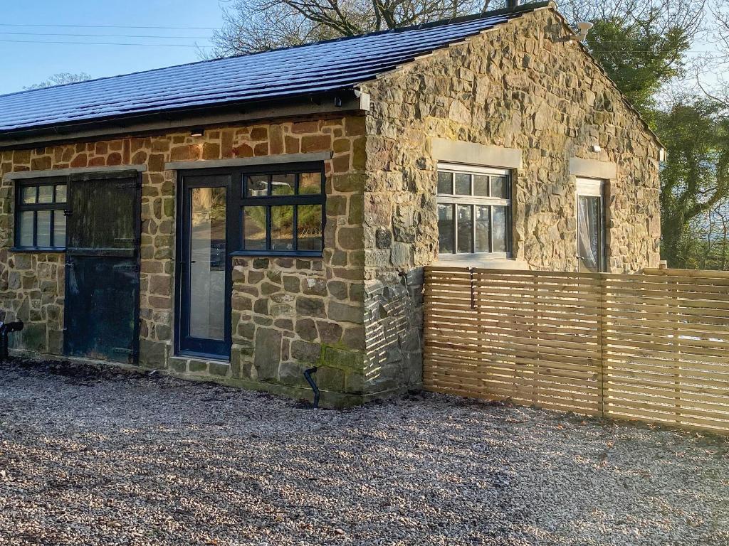 a stone building with a door and windows at Serenity- Uk38551 in Endon