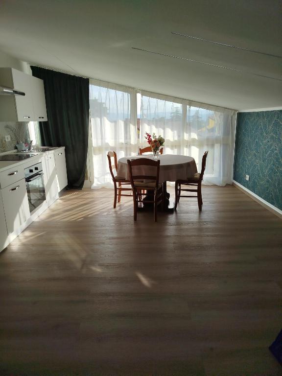 a kitchen with a table and chairs in a room at Light Loft Marsciano in Marsciano