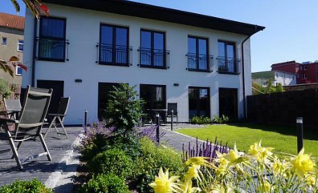 a house with chairs in front of it at Central Suites in Greifswald