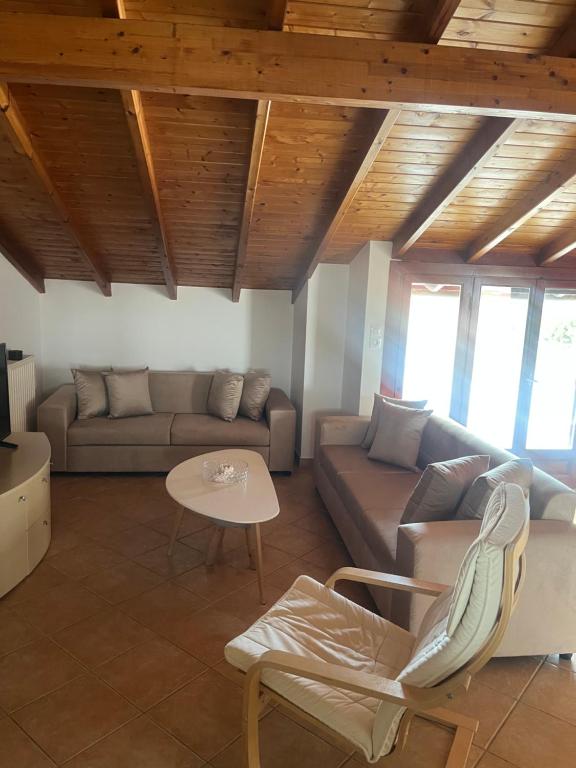 a living room with a couch and a table at Hera Loft in Ireon