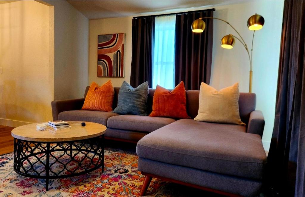 a living room with a couch and a table at Ambervine in Lowell