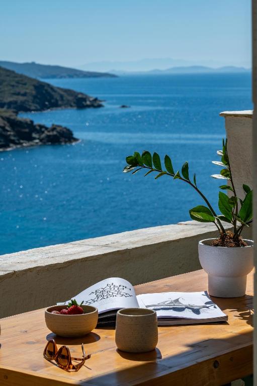 a wooden table with a view of the ocean at Kyma in Kardhianí