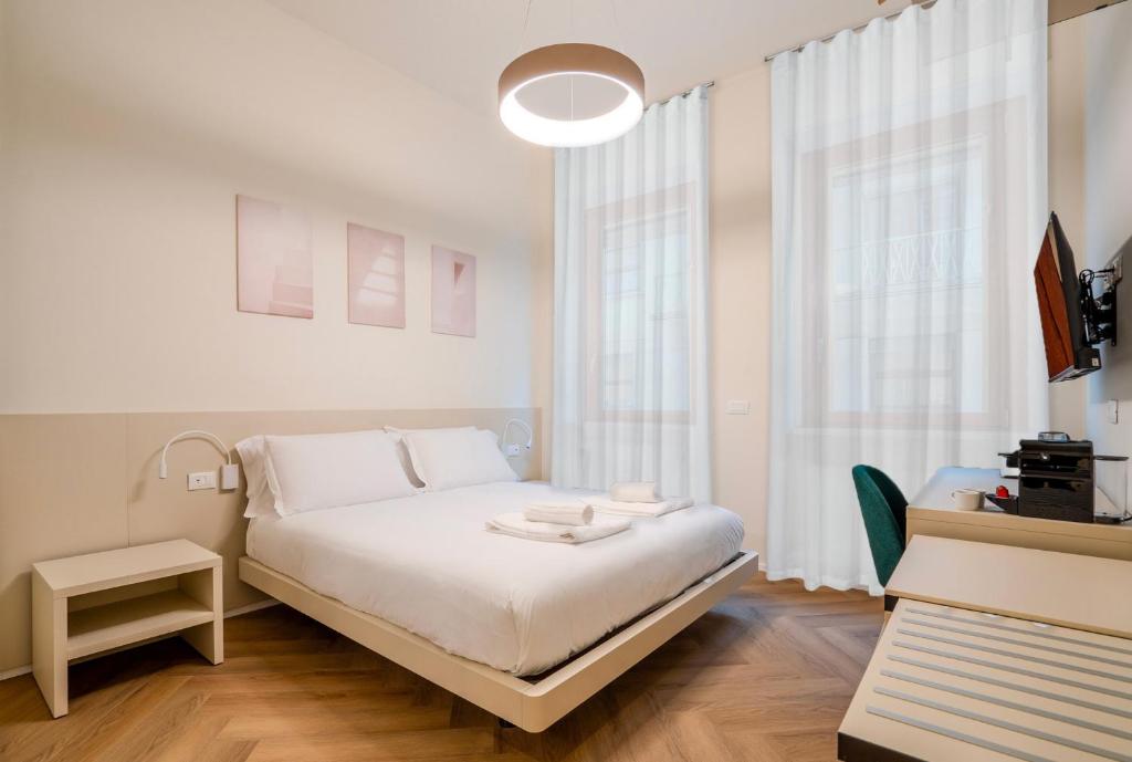 a bedroom with a white bed and a large window at Italianflat - Duomo Atmosphere Two in Milan