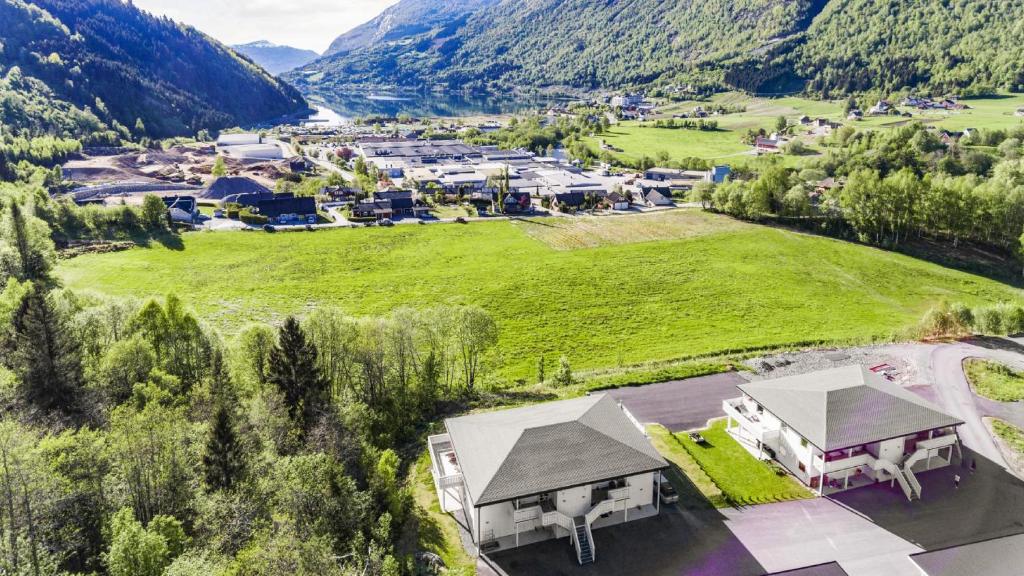 an aerial view of a house in a field with mountains at Kvitefjell 35 in Loen