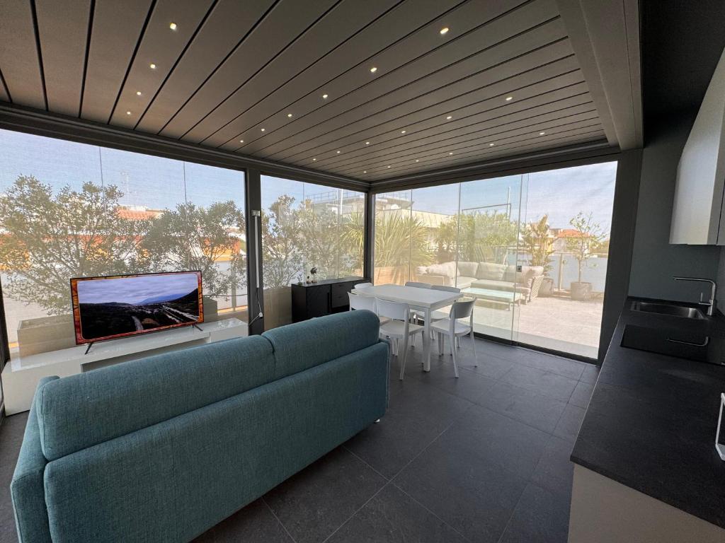 a living room with a blue couch and a table at Elegance Suite Apartments - Siroli Collection in Cervia