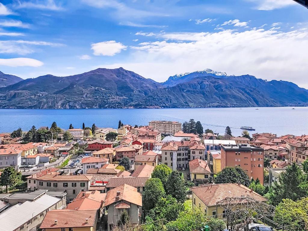 a view of a town with a lake and mountains at Apartment Lakeview Menaggio by Interhome in Menaggio