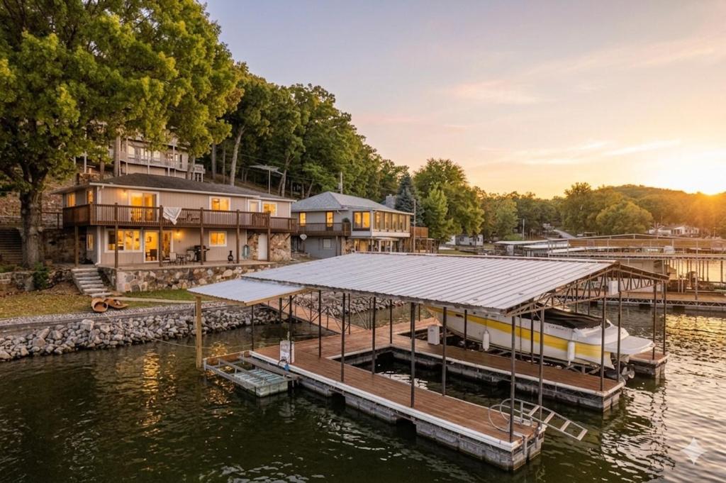 a house on the water with a dock at Markley Manor - Beautiful views in Sunrise Beach