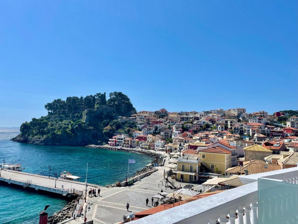a view of a town next to the water at Olympic Apartments in Parga