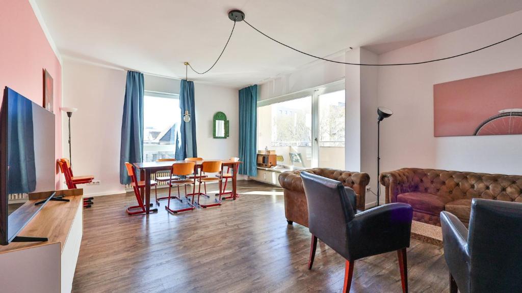 a living room with a couch and a table at Spacious Flat 2nd Floor near station in Karlsruhe