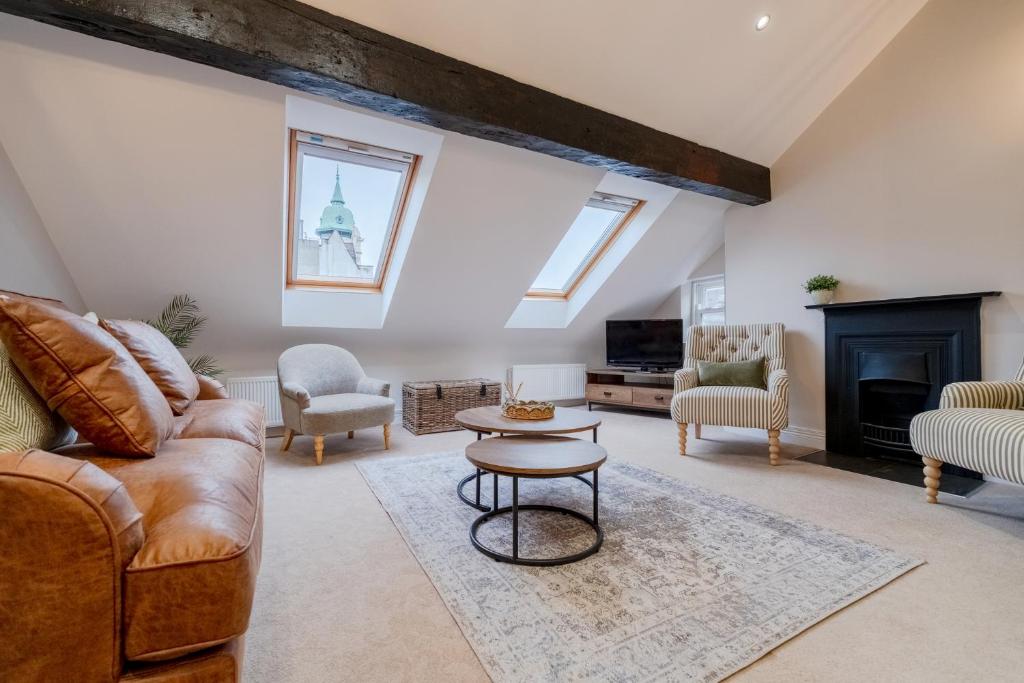 a living room with a couch and a fireplace at Pump House Apartments in Derry Londonderry