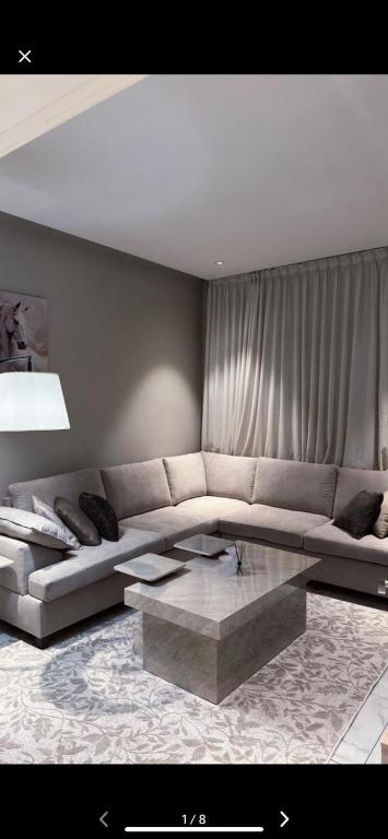 a living room with a couch and a coffee table at غرفتين وصالة بدخول ذكي in Al Kharj