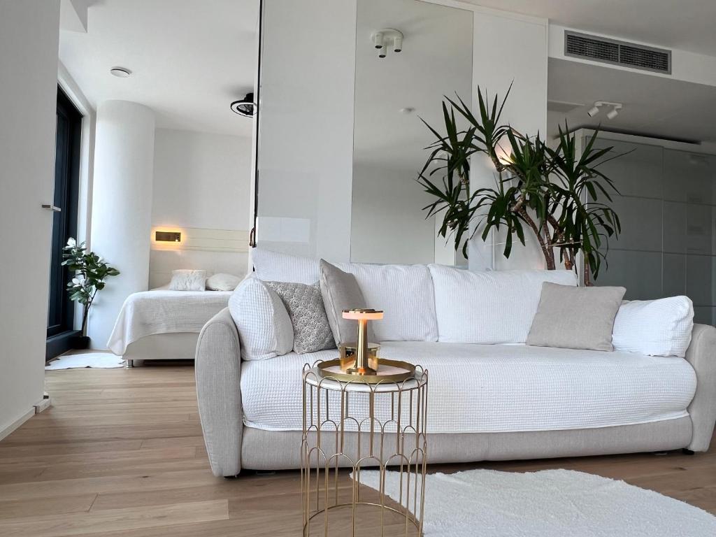 a living room with a white couch and a table at DeLux Apartment Koper - NEW in Koper