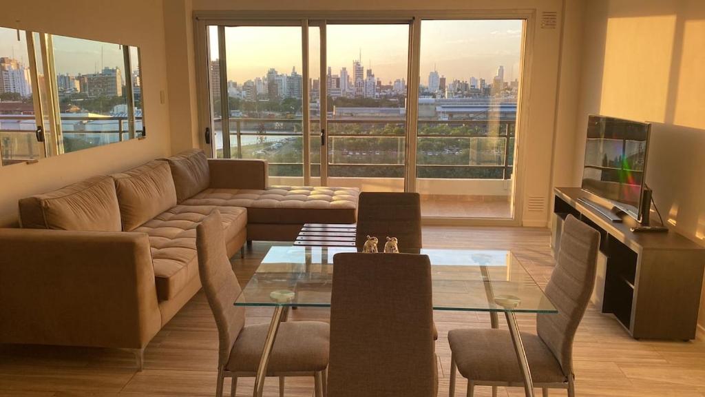 a living room with a couch and a glass table at Puerto Amarras Apartment in Santa Fe
