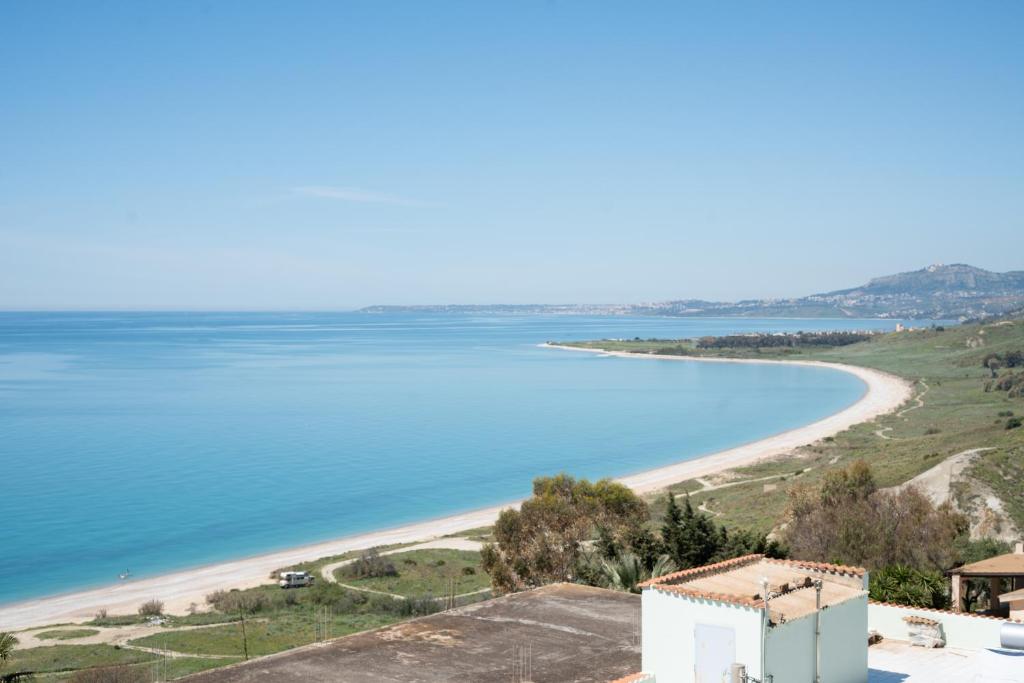 a view of a beach with a house and the ocean at Suliventumari in Ribera