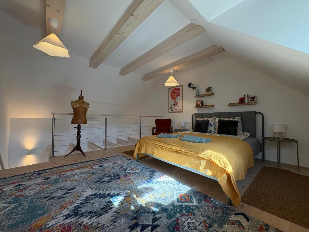a bedroom with a king sized bed in a attic at ZadorHomes Etyek in Etyek