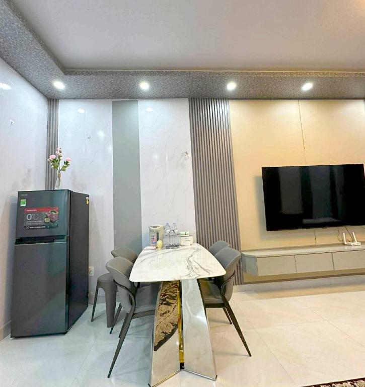 a living room with a table and a tv at Phốstay 180 Cầu Đất in Hai Phong