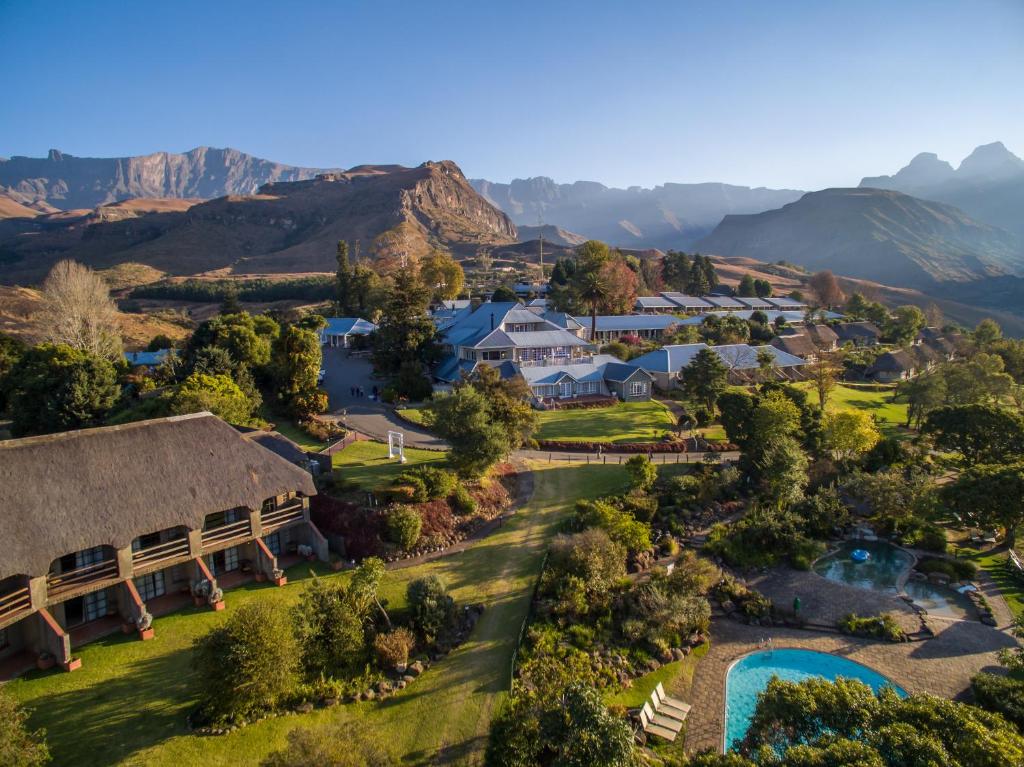 an aerial view of a resort with mountains in the background at Cathedral Peak Hotel in Amanzana