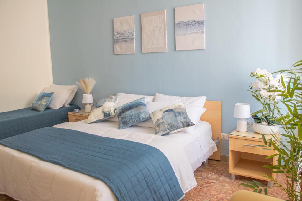 a bedroom with a bed with a blue blanket at Actinia Accommodation in Alghero
