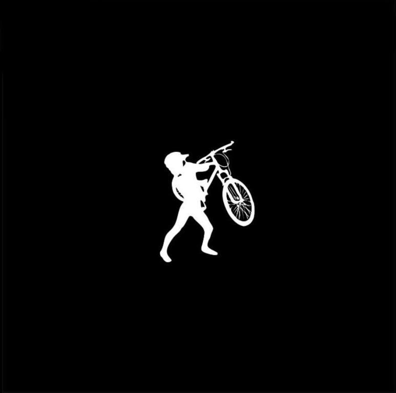 a man is carrying a bike on his shoulder at Son Mandrivnyka in Rakhiv