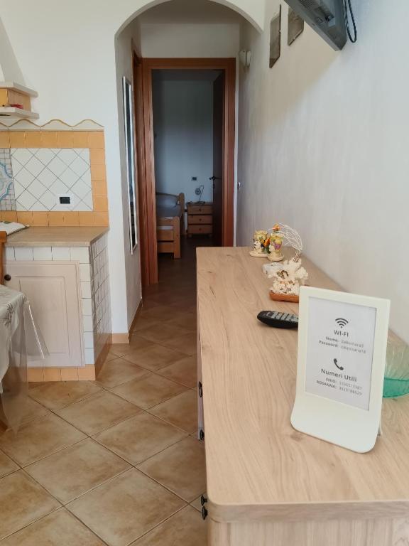 a kitchen with a counter with a sign on it at Appartamenti Za Barbara in Lampedusa