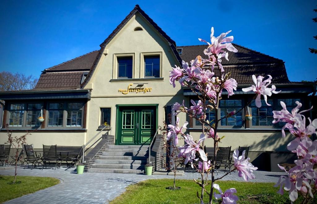 a house with a green door and purple flowers at Haus Stenzinger in Burg