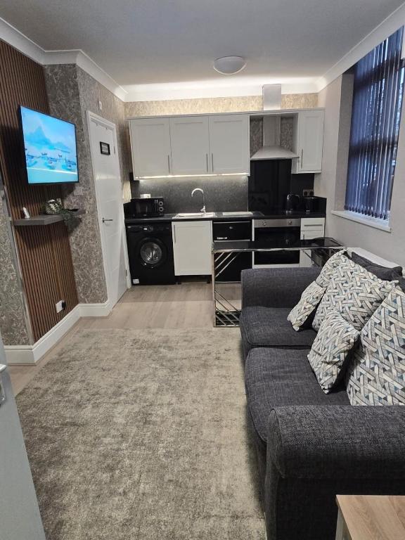 a living room with a couch and a kitchen at Levy Nook 6 in Darlington