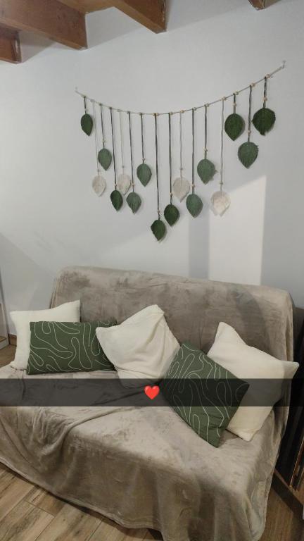 a couch with pillows on it in a living room at Studio Dennebroeucq in Dennebroeucq