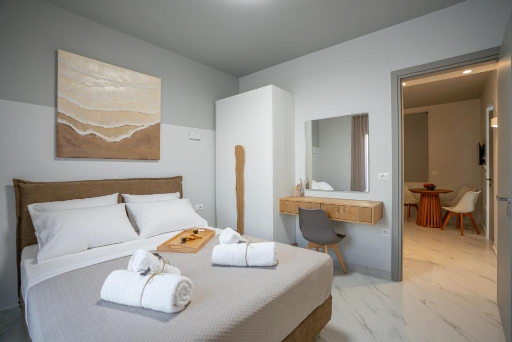 a bedroom with a bed with towels on it at Agora Luxury Suites in Lixouri