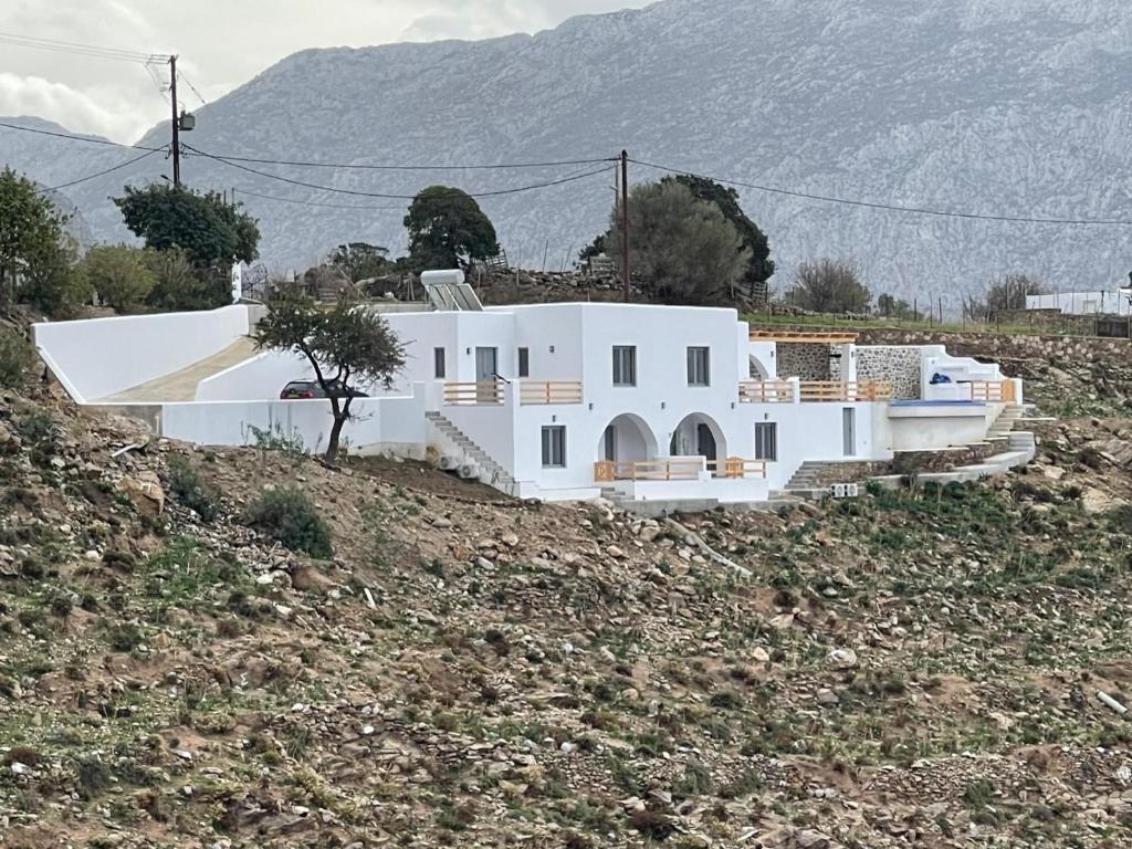 a white house on top of a hill at Shaunagh's Place Crag Apartment in Kalymnos