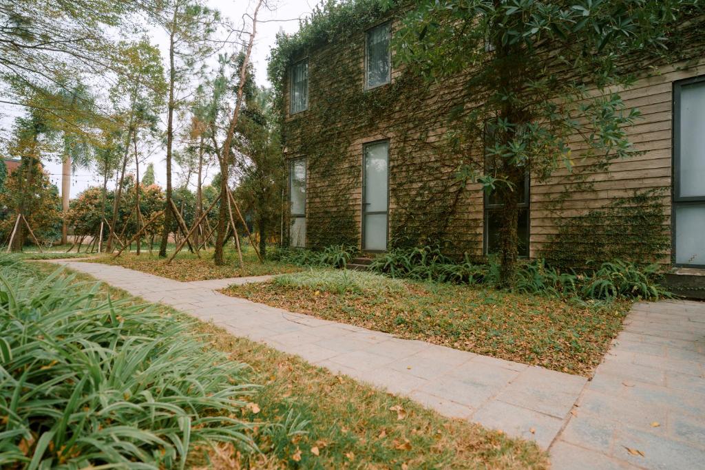 a brick building with a sidewalk in front of it at Veco Pine in Thạch Cầu