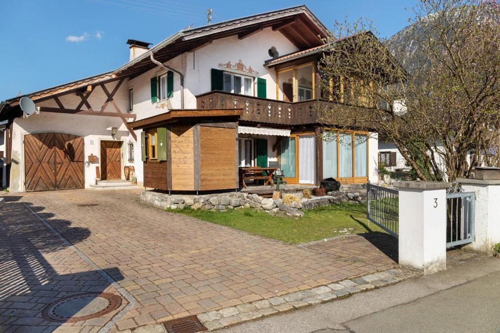 a house with a brick driveway in front of it at Andis Ferienwohnung in Farchant