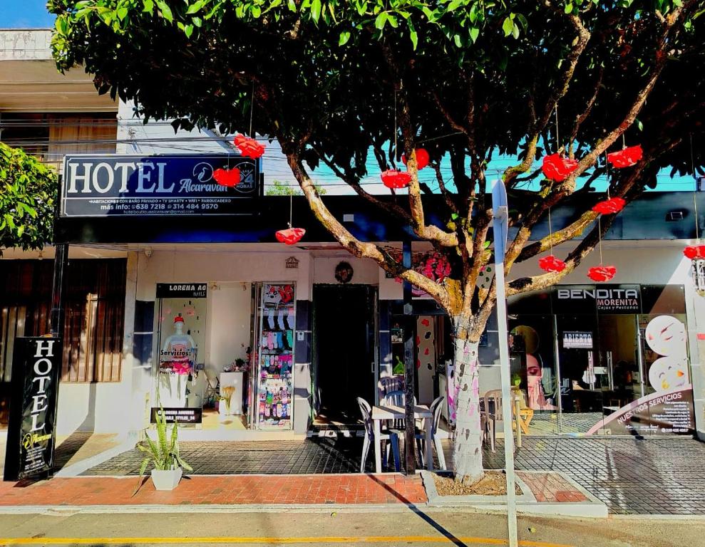 a store front with a tree in front of it at Hotel Alcaraván Aguazul in Aguazul