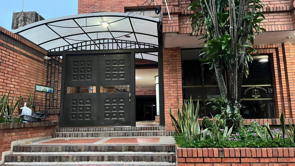 a black door on a brick building with stairs at Arauca -Centro in Arauca
