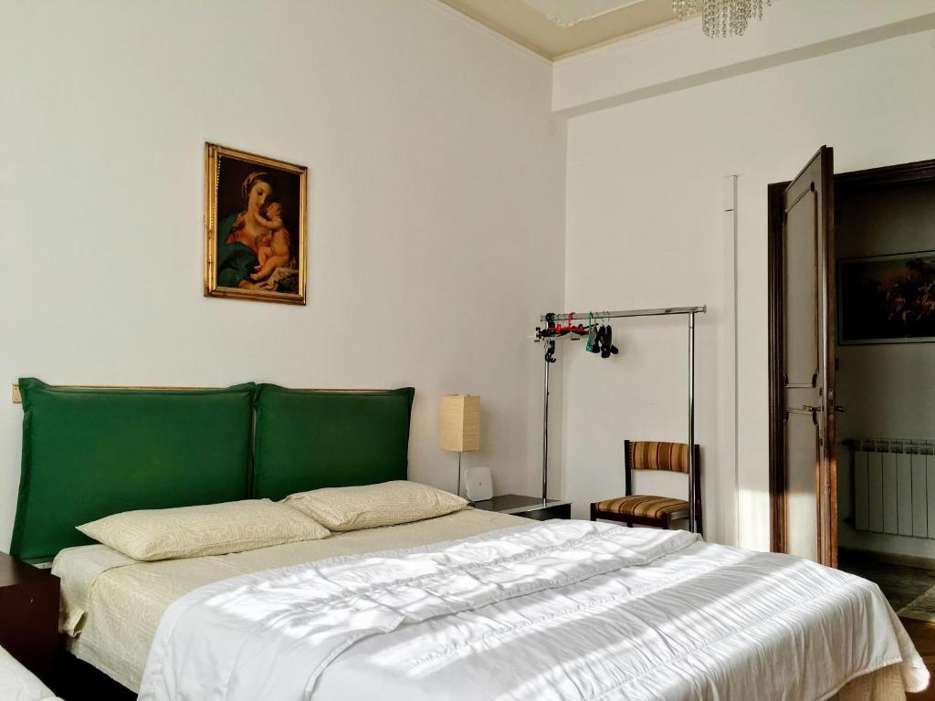 リード・ディ・ヴェネツィアにあるLiberty Style Apartmentのベッドルーム1室(緑のヘッドボード付きの大型ベッド1台付)