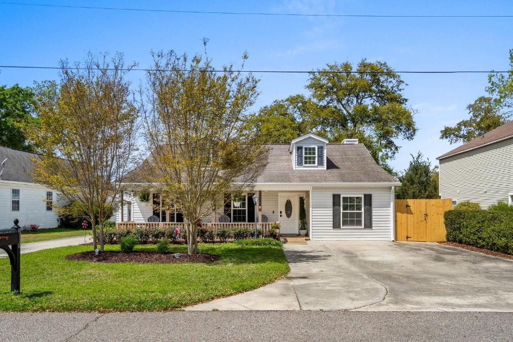 a white house with a driveway at Whispering Marsh Hideaway - Peaceful House in Myrtle Beach