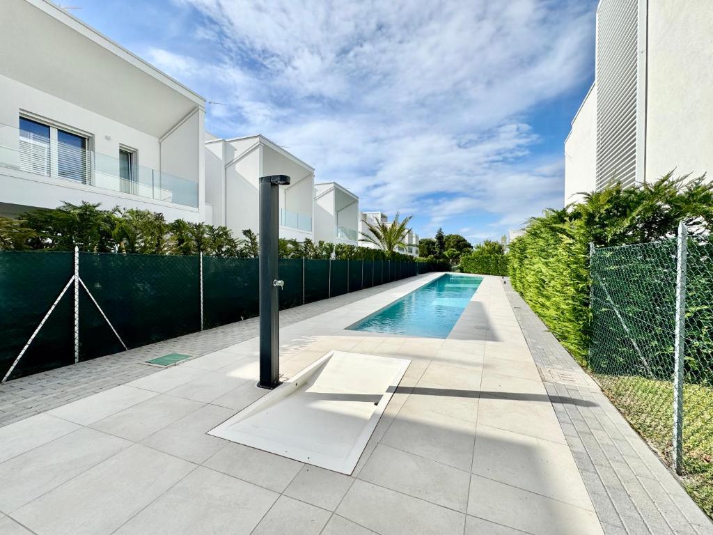 a swimming pool in front of a house at Villa 124 Residence in Lignano Sabbiadoro