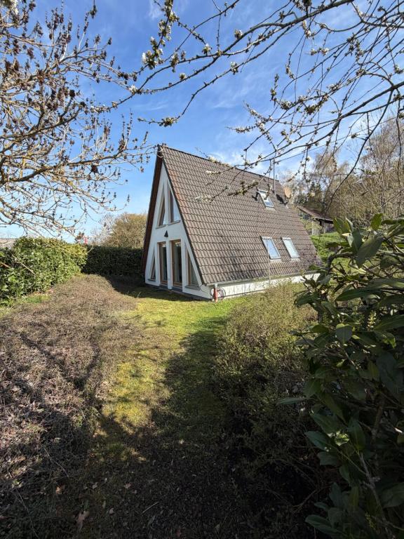 a white house with a brown roof on a yard at Giebelblick Barweiler in Barweiler