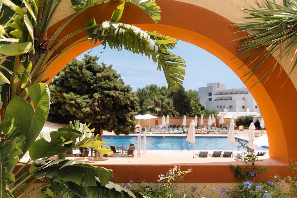 an orange archway over a swimming pool with a resort at BLUESEA Salina Ex MD Atlantic in Es Cana