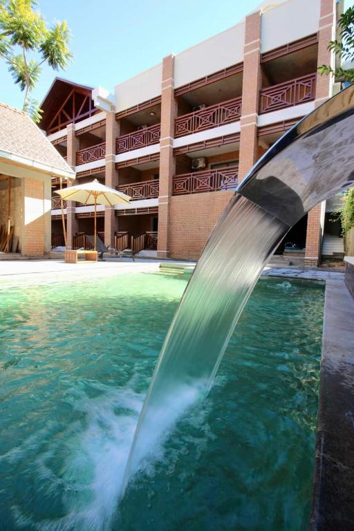 a water fountain in front of a building at La Colongette in Antsirabe