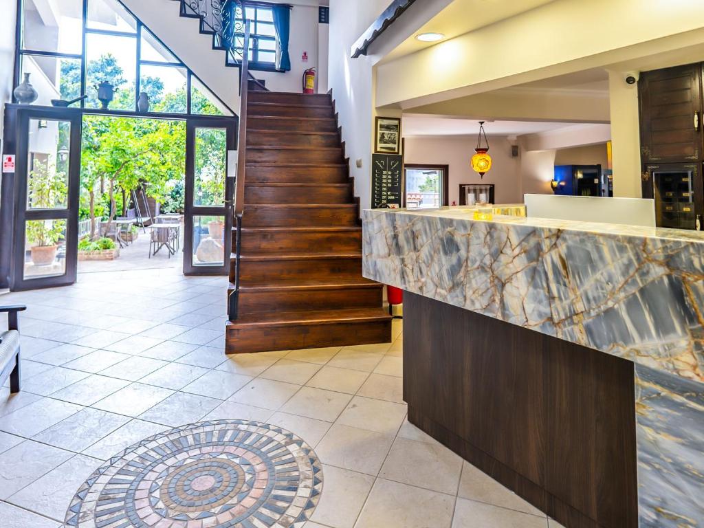 a lobby with a staircase and a counter at Morea Kaleiçi-Adults Only in Antalya