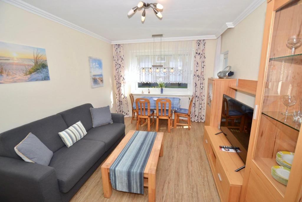a living room with a couch and a table at Appartement-124 in Westerland