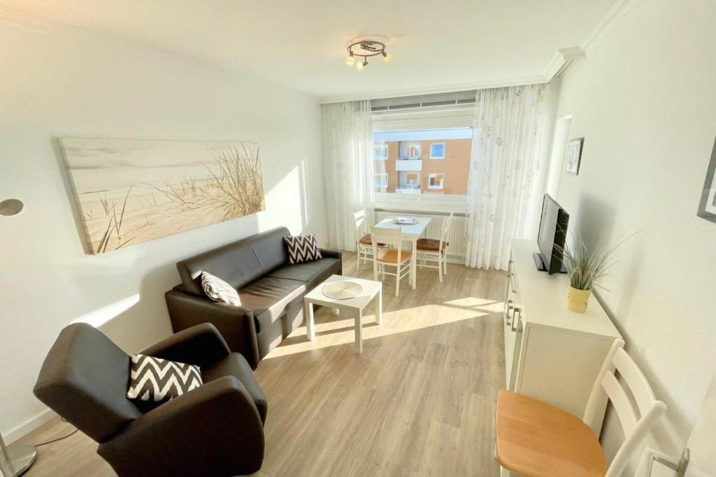 a living room with a couch and a table at Appartement-162 in Westerland