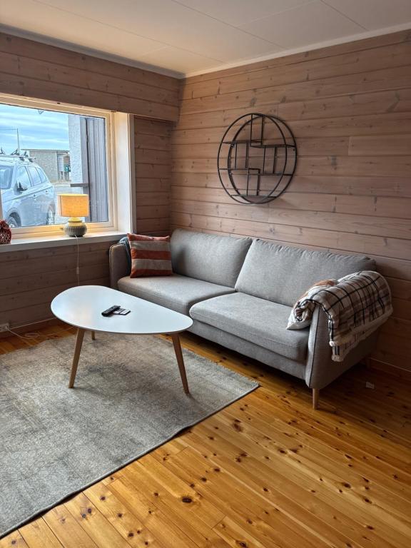 a living room with a couch and a table at Sissels Guesthouse in Andøya